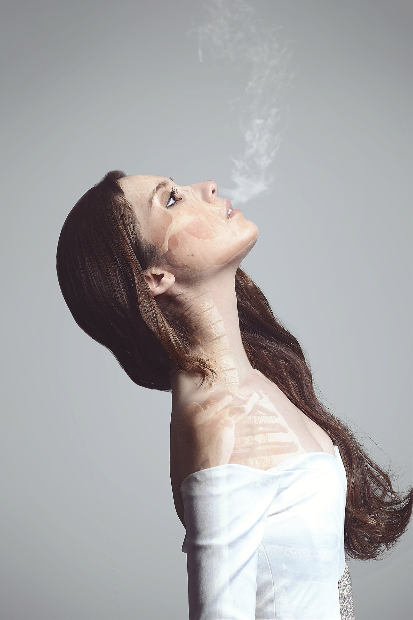 Melissa Lee a model with long brown hair exhales smoke which merges with an anatomical illustration of her neck and upper torso creating a surreal juxtaposition of the ethereal and the biological.